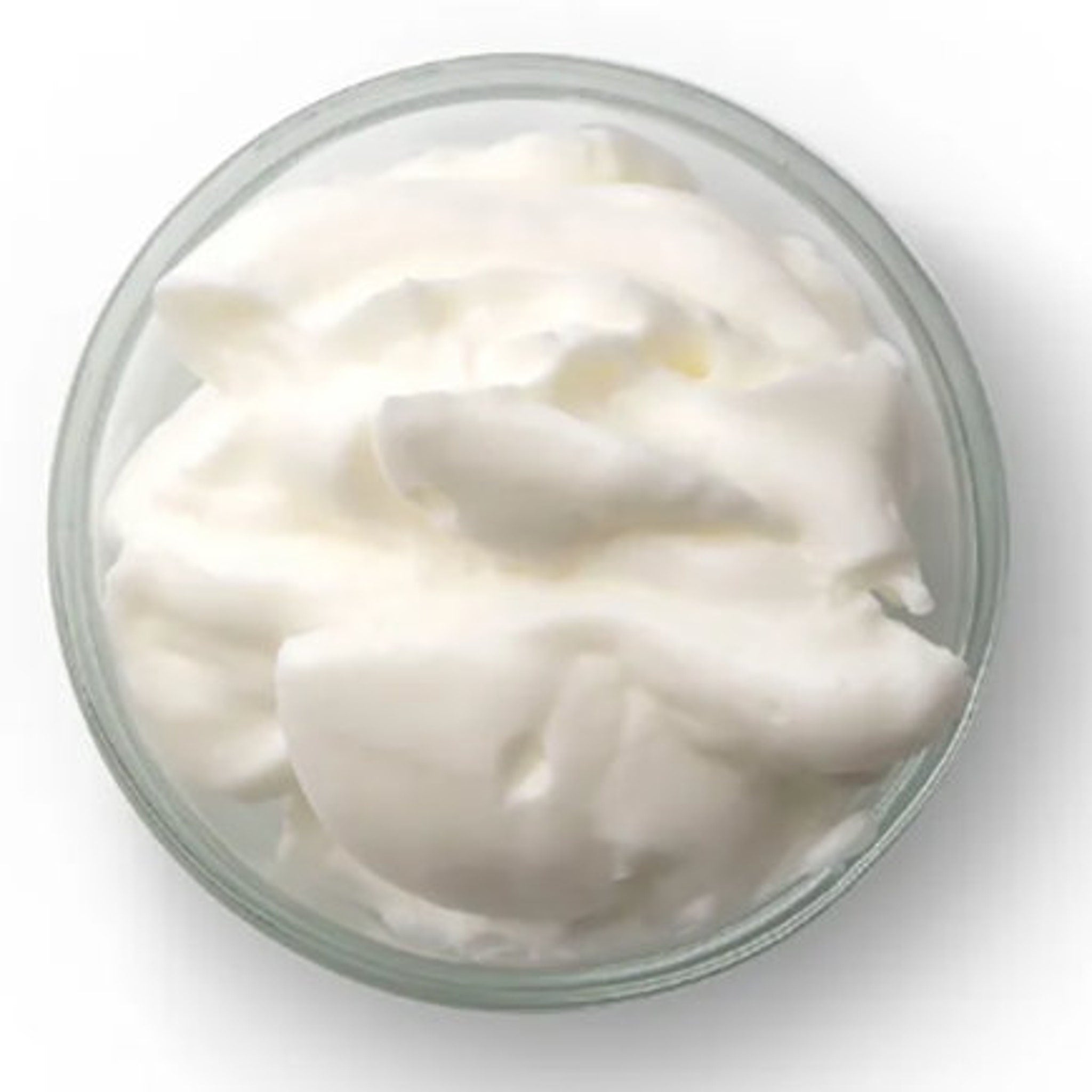 Cream in a clear glass bowl, white and textured, top view