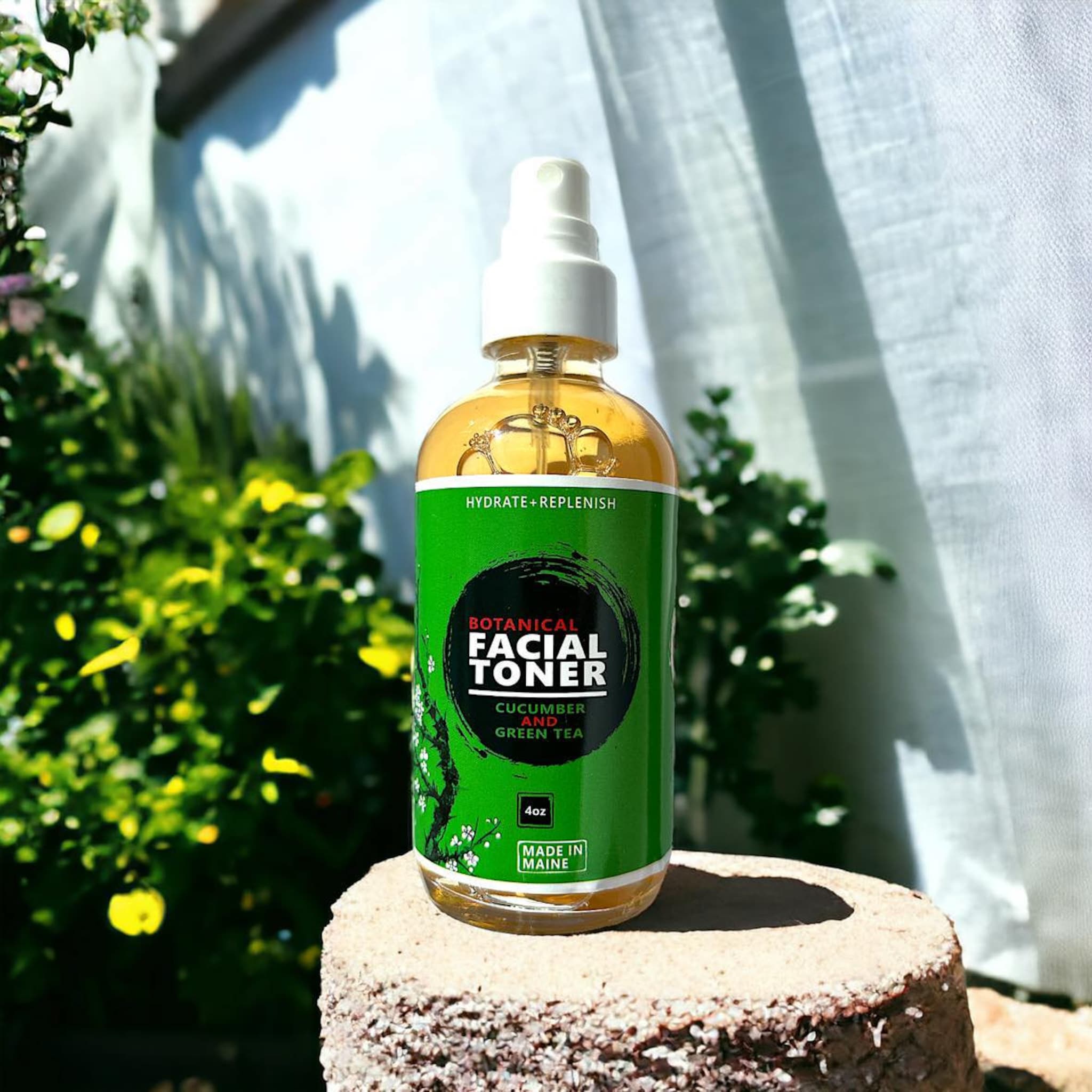 Facial Toner bottle with green label, clear liquid, and white spray top on a stone base