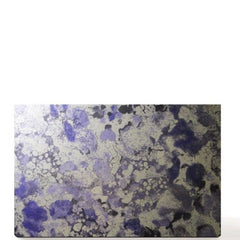 Side view of double-sided purple marble eye shadow palette showing magnetic closure and mirrored interior