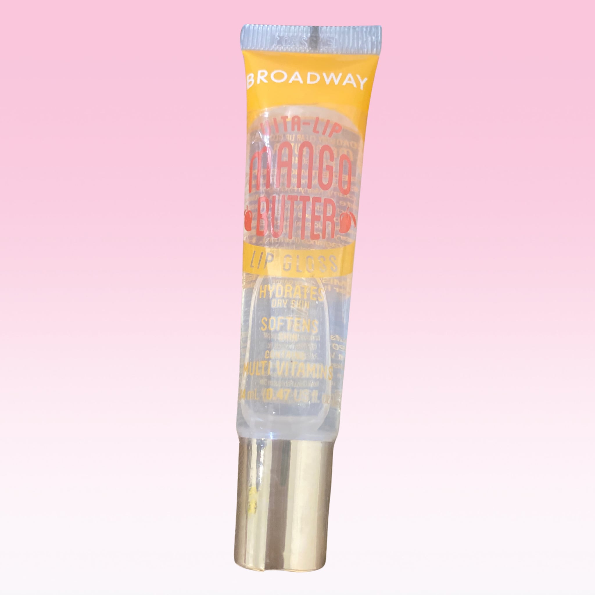 Lip gloss tube with yellow and clear packaging, Broadway Vita Soft brand name visible, gold base