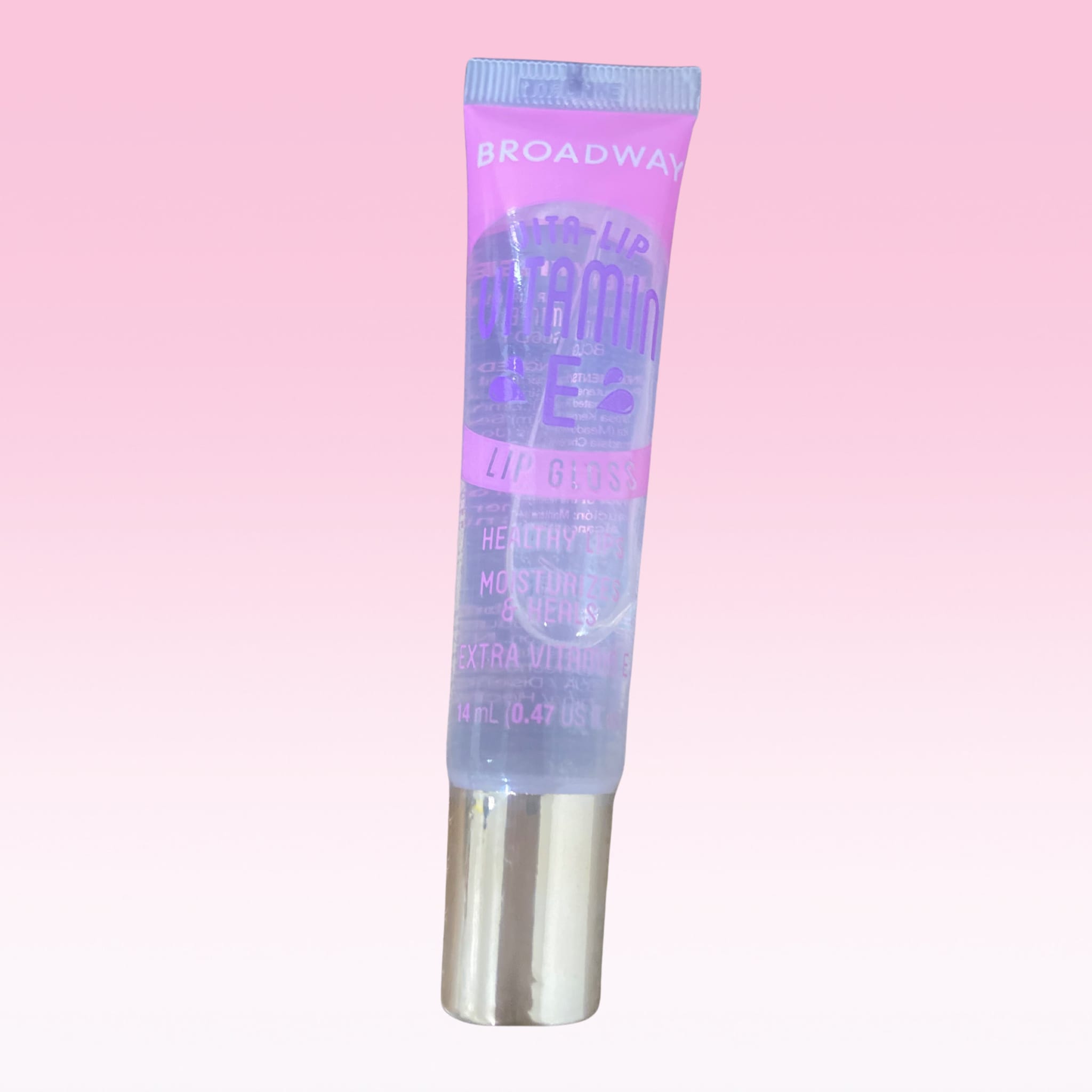 Lip gloss tube with clear gloss, purple label, and silver cap, Broadway brand visible