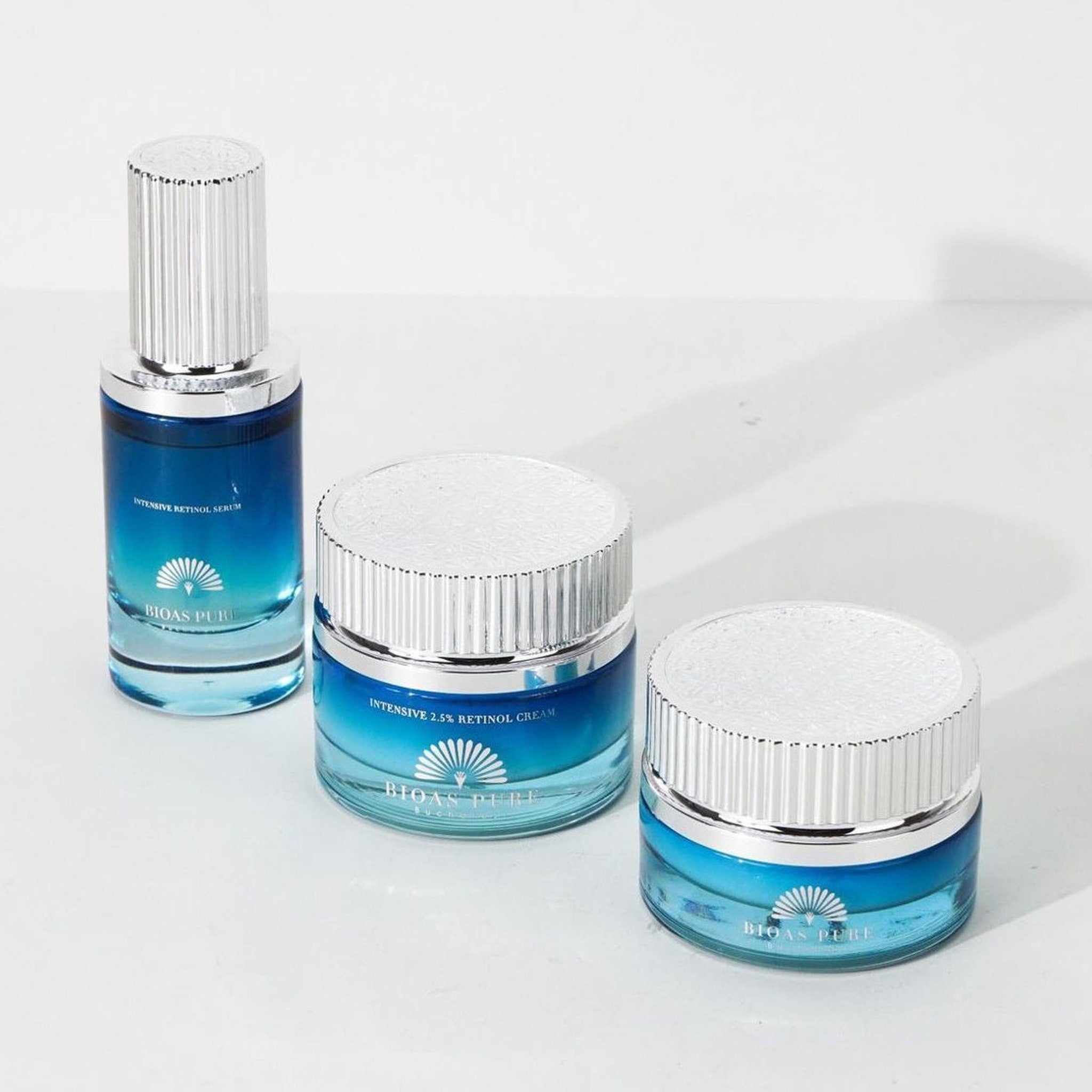 Retinol serum and cream set with blue glass, silver lids, and BIOAS PURE branding visible