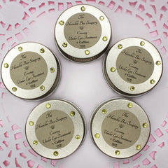 Under eye treatment in silver tins with yellow gems and The Humble Bee Soapery label on pink background