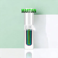 Close-up of multichrome liquid eyeshadow shifting between emerald green and sapphire blue hues