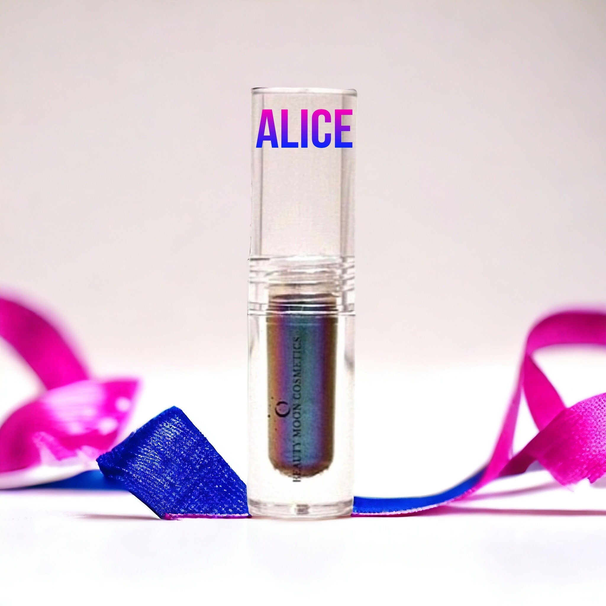 Side view of multichrome liquid eyeshadow bottle showing iridescent purple-green shift in sleek tube packaging