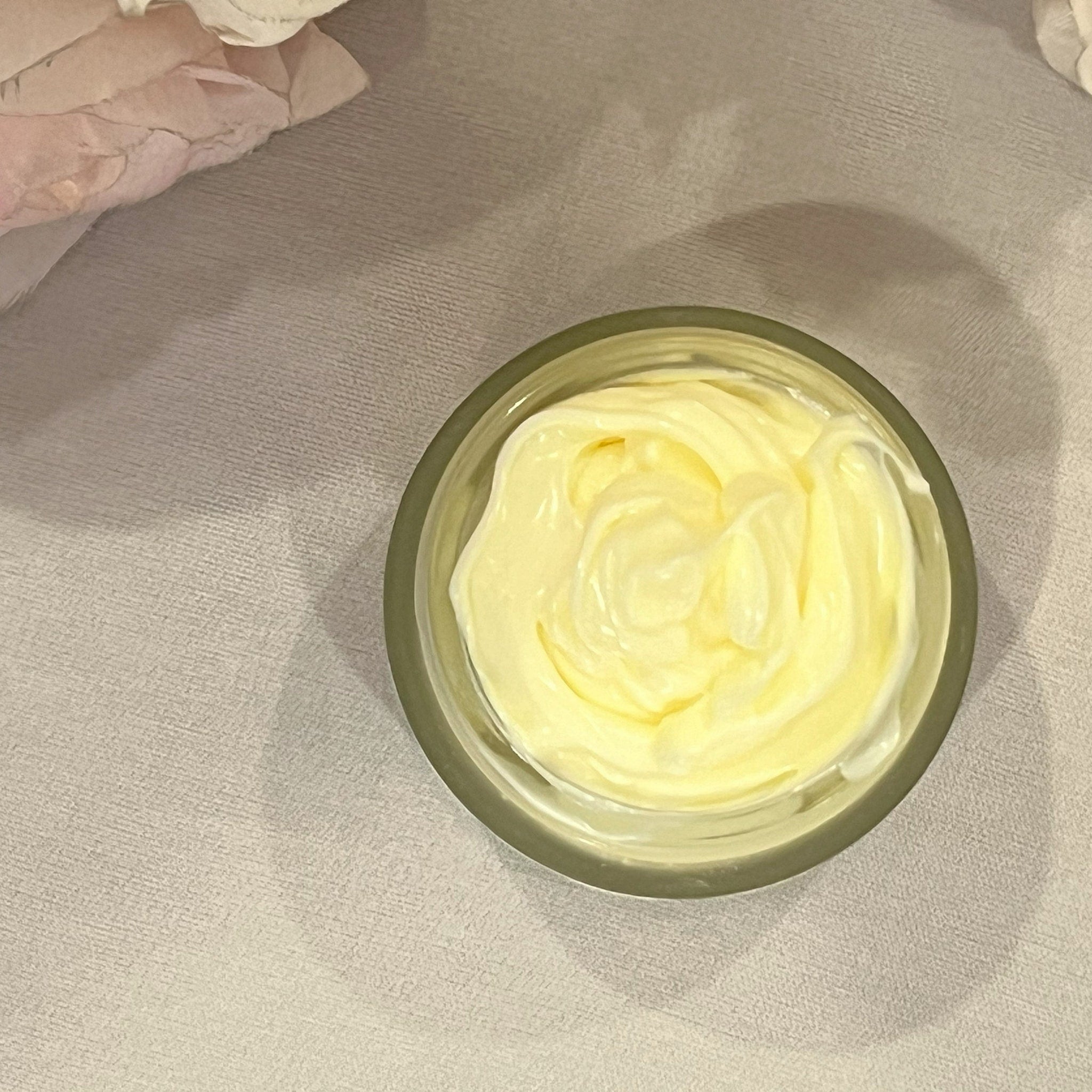 Minimalist white jar of Revitalizing Ultra Sculpt Face Cream with gold accents on clean marble surface