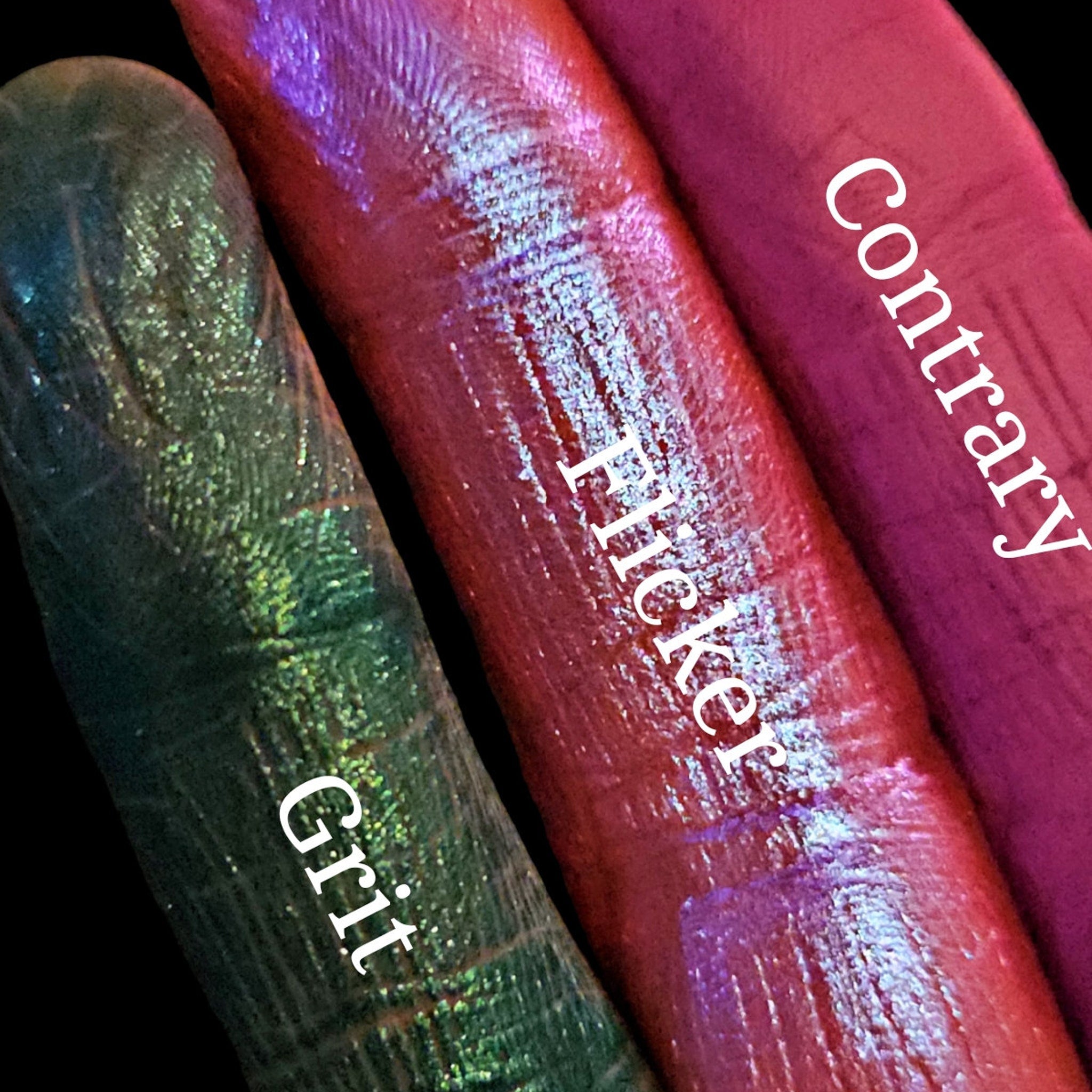 Side view of Divergence palette showing stacked eyeshadow pans with vibrant matte and shimmer shades in sleek black packaging