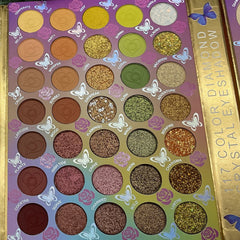 Eyeshadow palette with various colors, heart-shaped design, and butterfly accents, "117 Color Diamond Eyeshadow" text visible