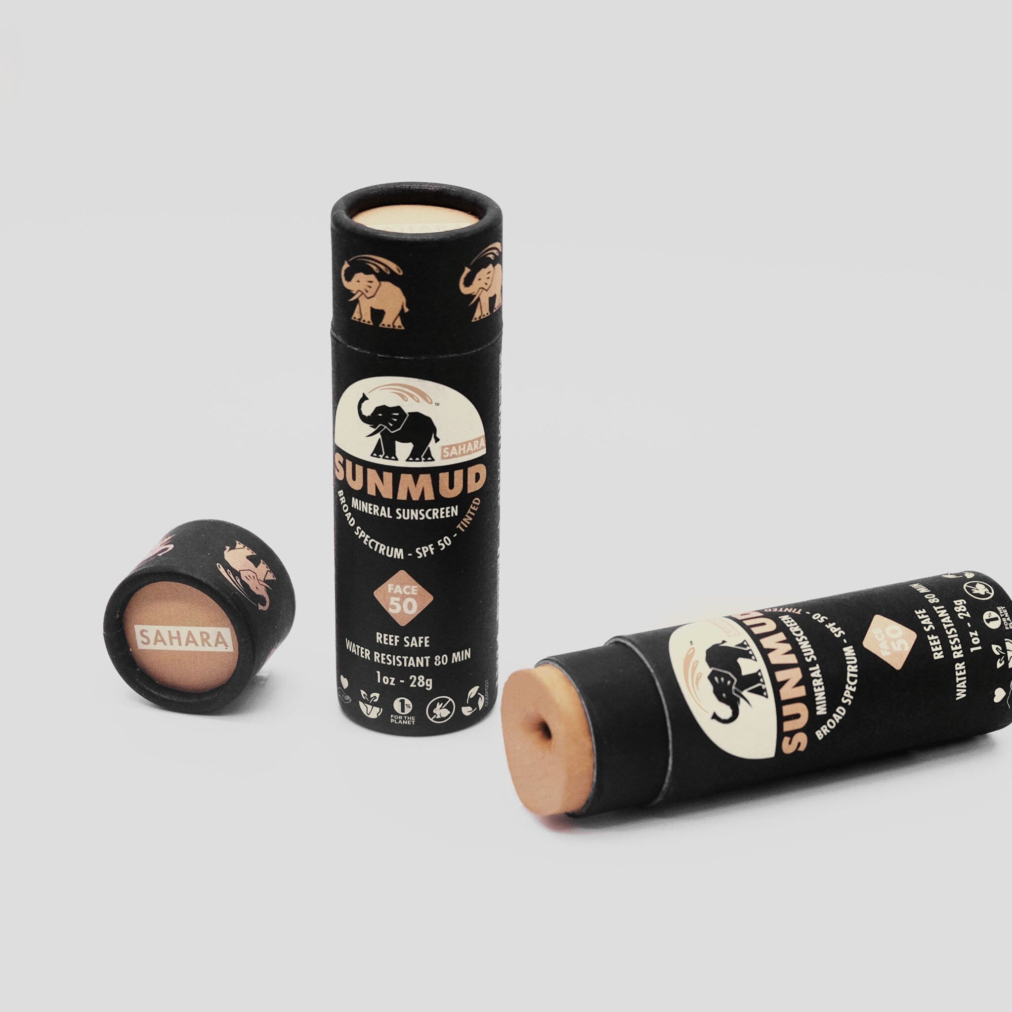 Sunscreen stick with black and tan packaging, "SAHARA SUNMUD" brand name visible, and elephant logo on tube