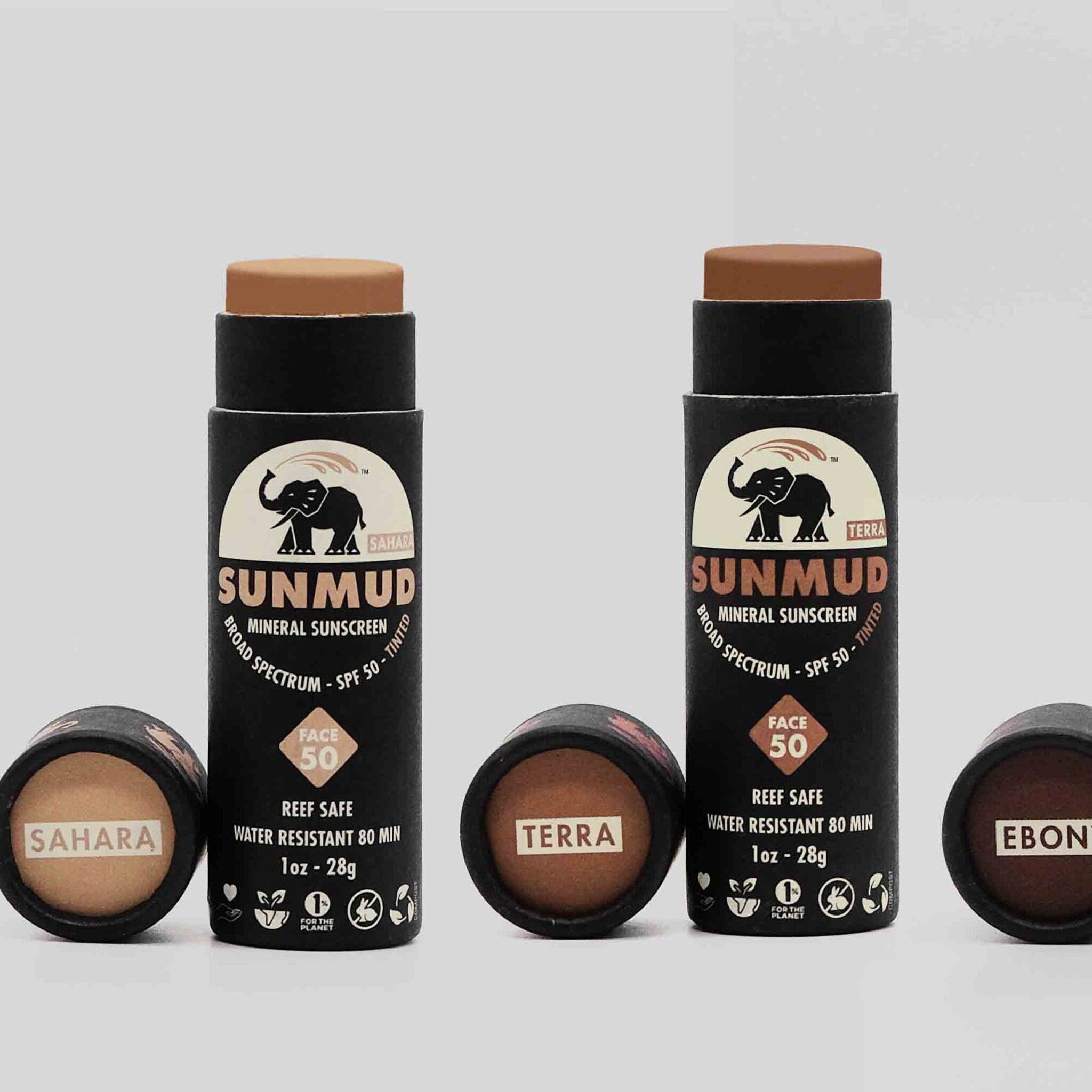 Sport stick sunscreen, black cylindrical tube with SUNMUD text, brown tinted sunscreen visible, SPF 50