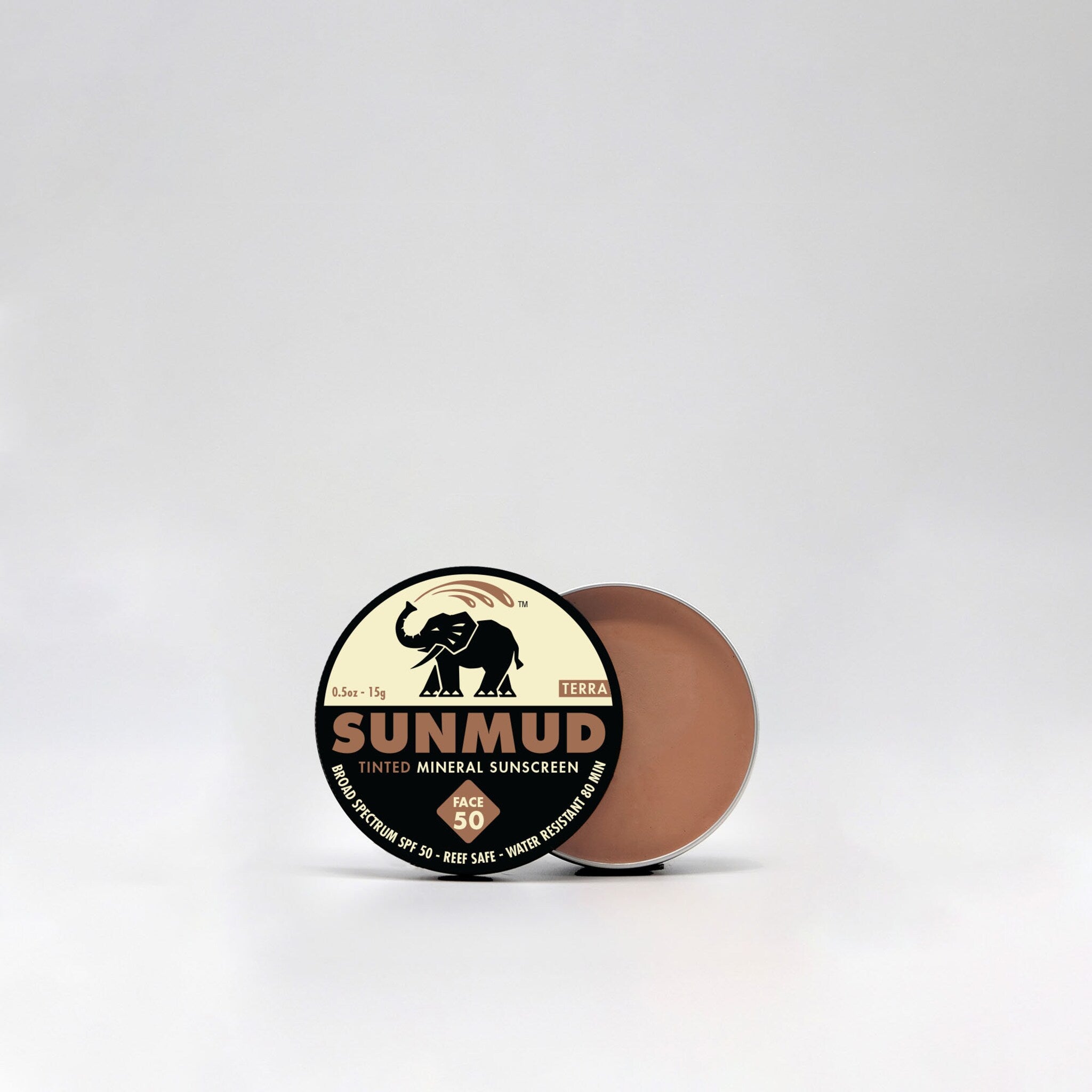 SUNMUD tinted sunscreen, round container, brown cream, silver rim, product label visible