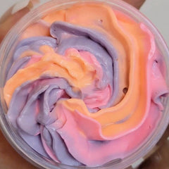 Elegant glass jar of whipped passionfruit-scented shea body butter with gold lid and creamy texture