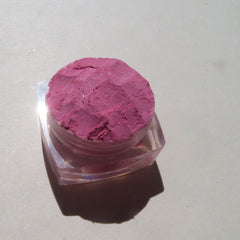 Close-up of loose bubblegum pink mineral eyeshadow with soft sheer finish, vegan and cruelty-free