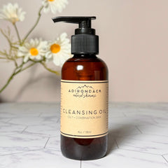 Cleansing oil bottle with brown glass, black pump, and beige label with Adirondack Natural Skincare text