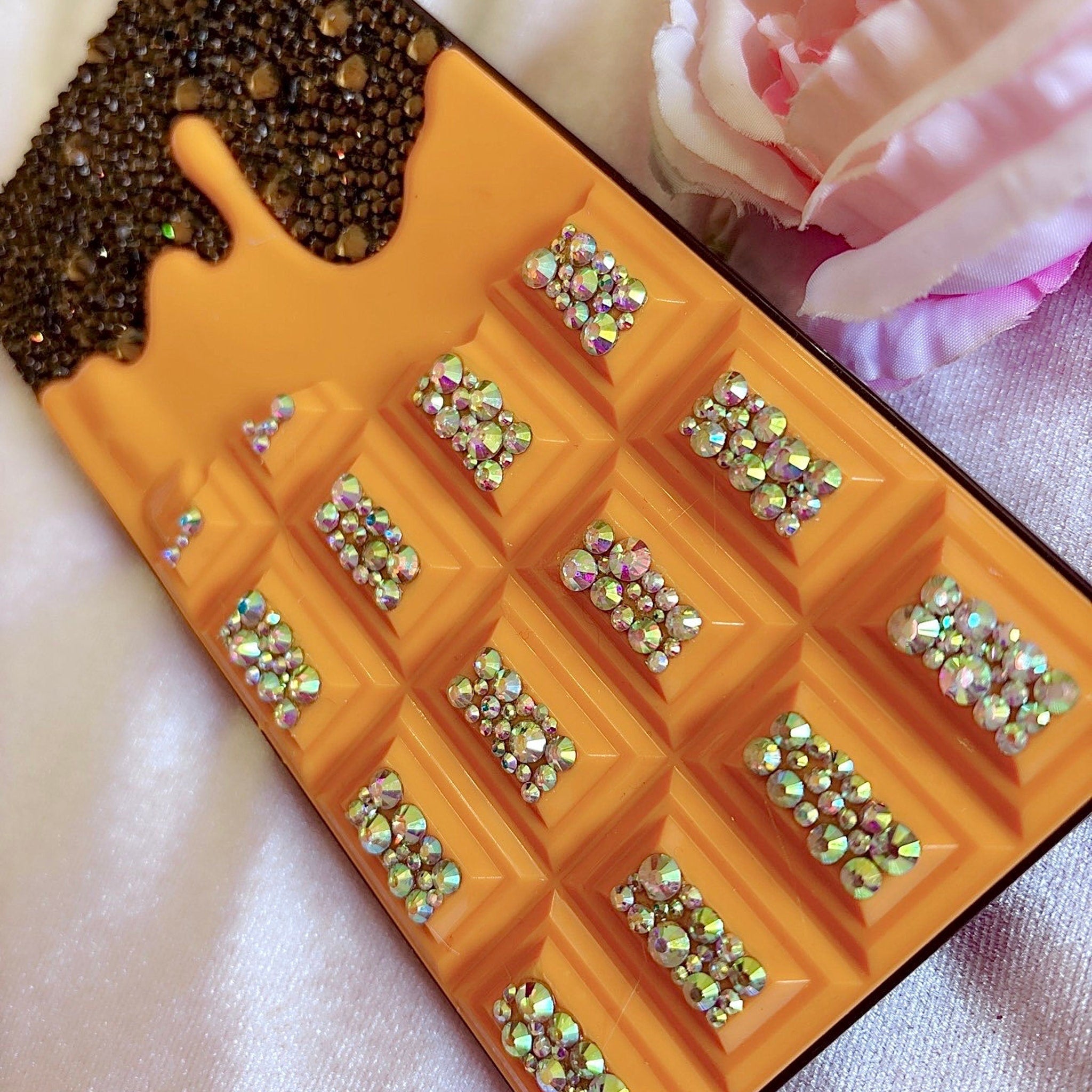 Side view of Chocolate Bar Eyeshadow Palette showing blinged glam shades in gold packaging with embossed logo