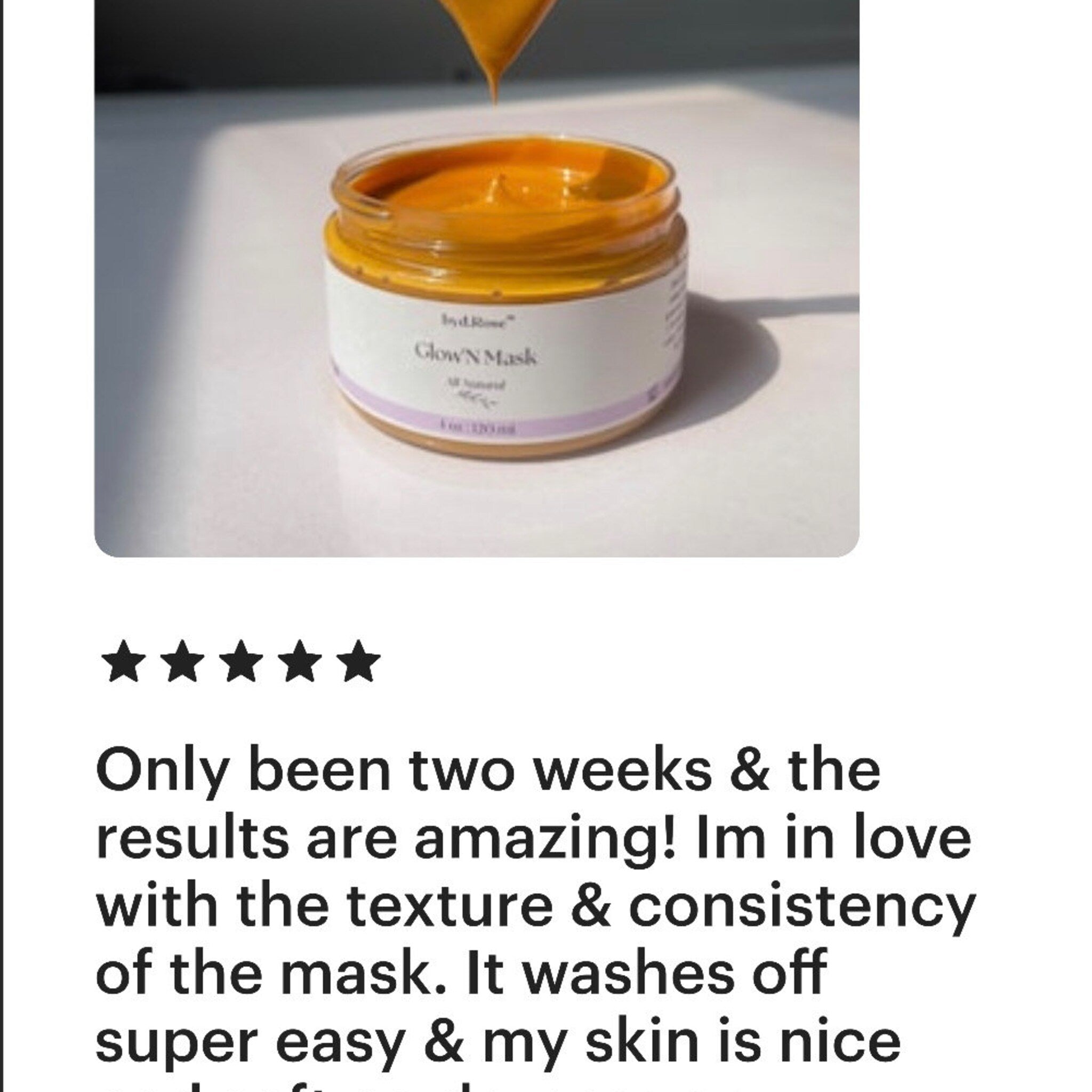 Face mask jar with orange contents, glass jar, and white label with text GlowN Mask