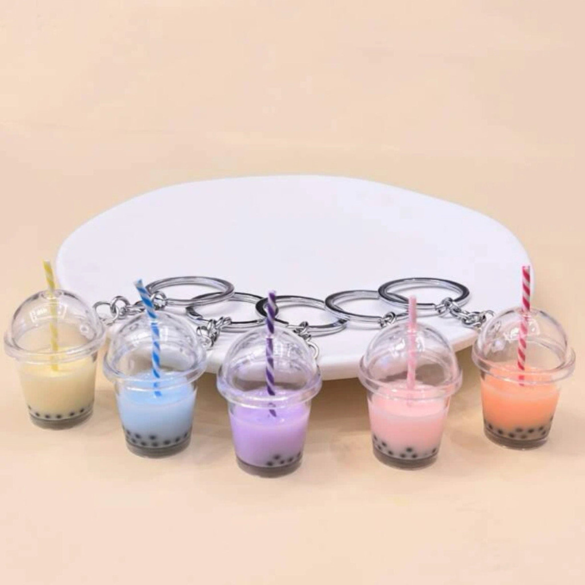 Keychain charms with colorful drinks in clear plastic cups and silver keyrings