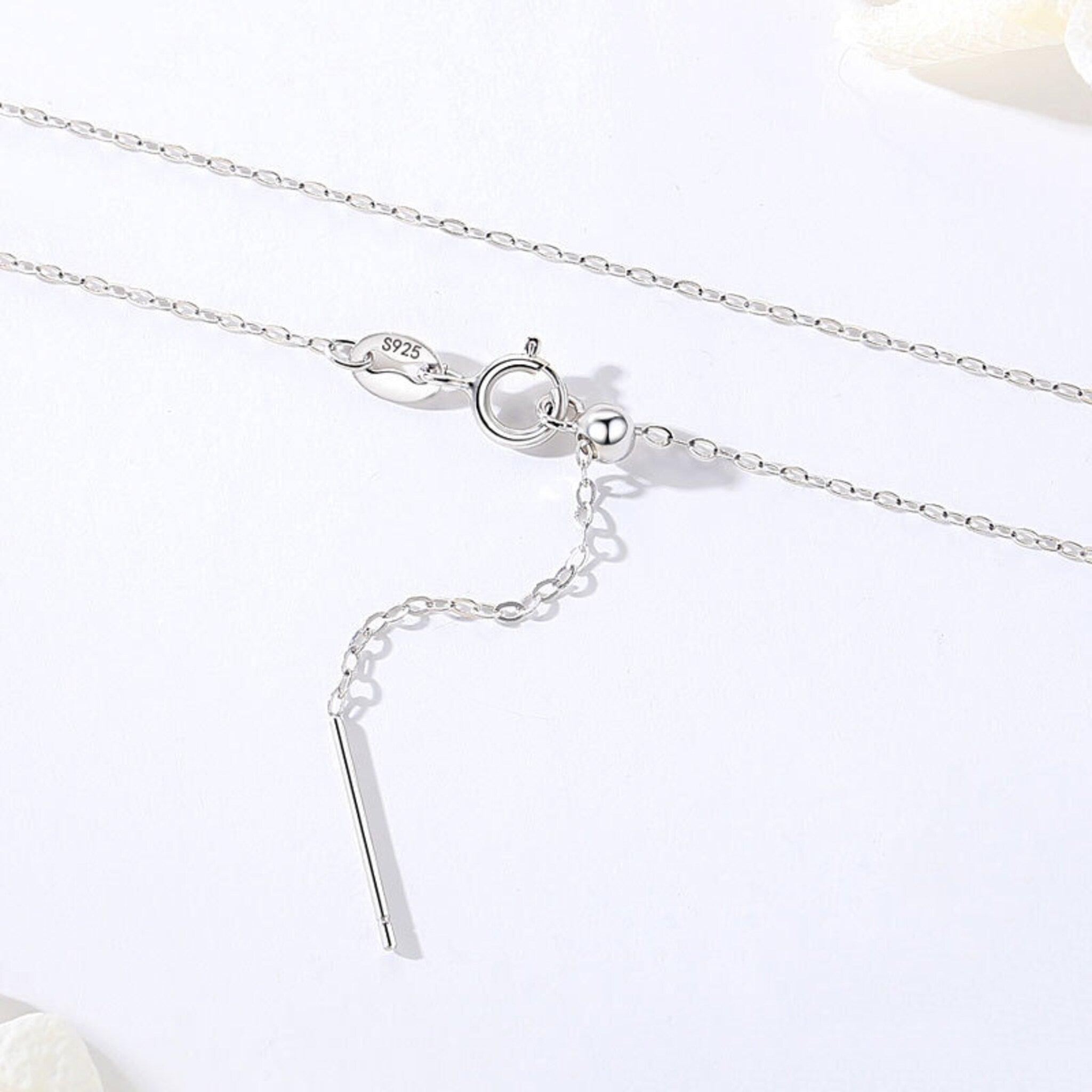 Side view of sterling silver chain necklace showcasing the polished metallic finish and delicate links