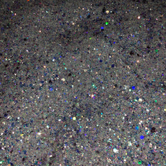 Close-up of iridescent white glitter eyeshadow with shimmering blue and pink hues in a compact case
