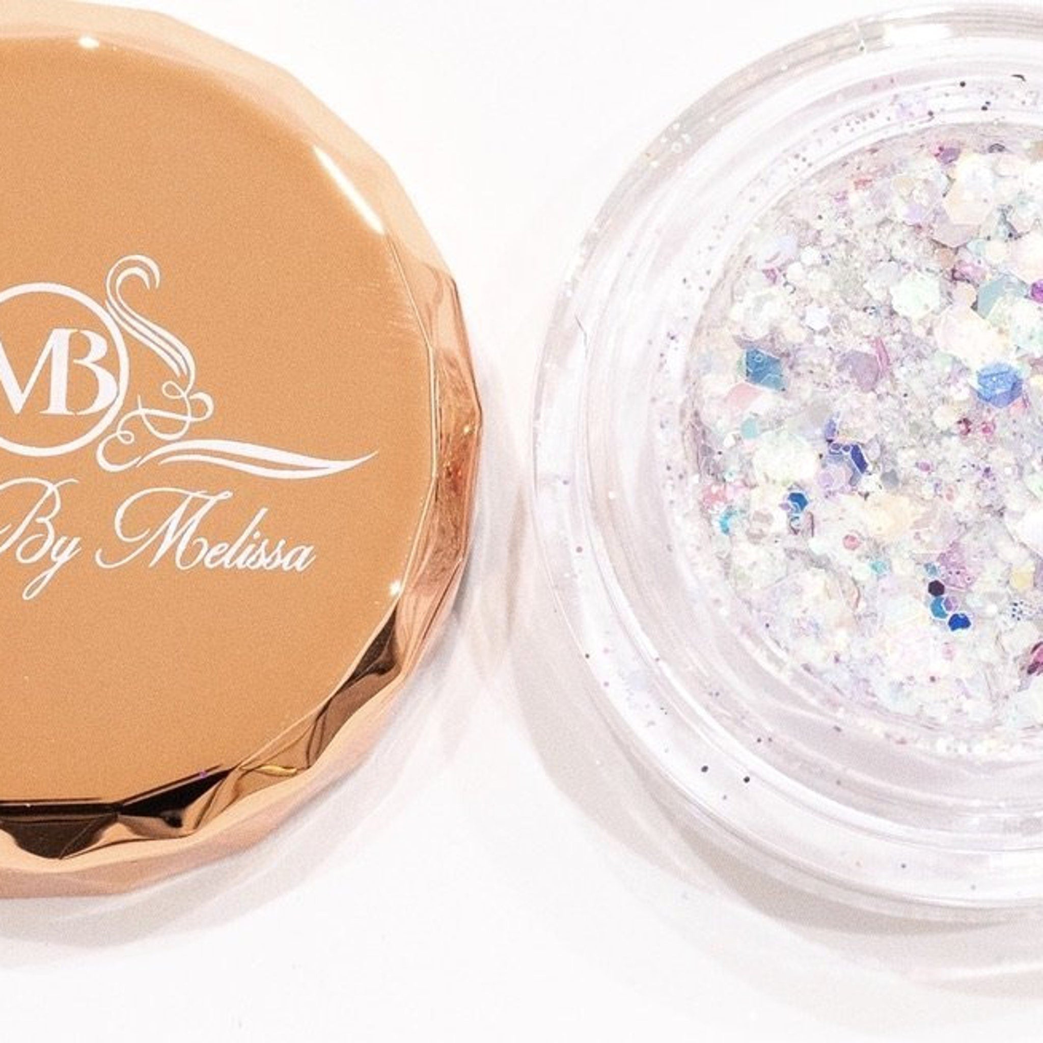 Side view of iridescent white glitter eyeshadow pot reflecting blue and pink shimmer in angled light