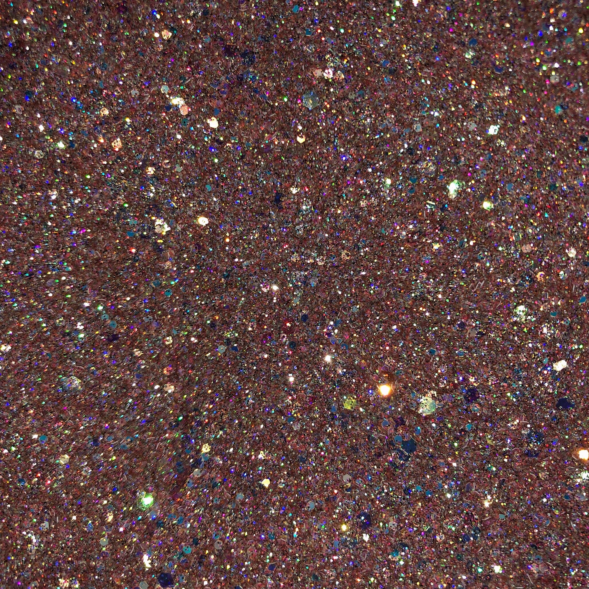 Close-up of rose gold glitter eyeshadow palette showing shimmer particles catching light