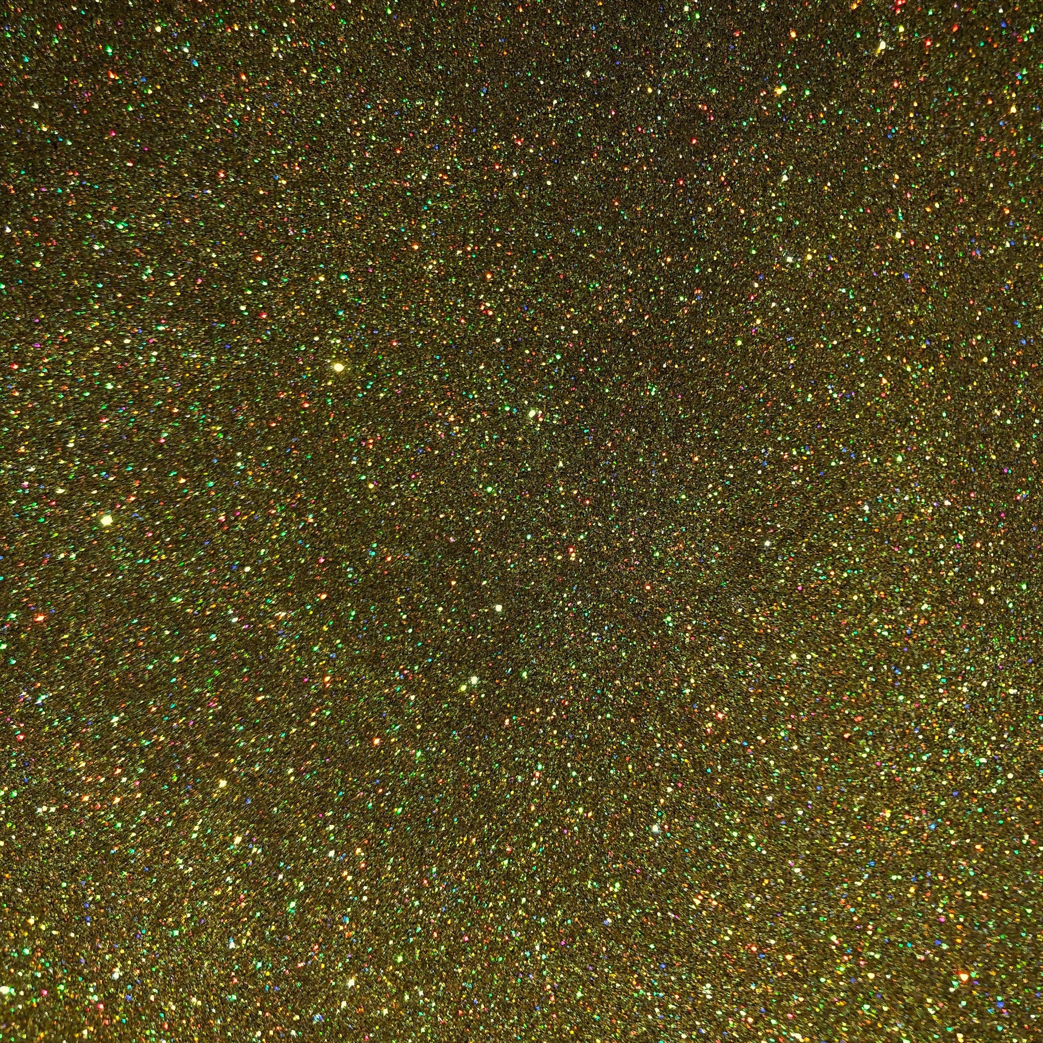 Close-up of holographic gold glitter eyeshadow pan showing shimmering multi-dimensional flecks