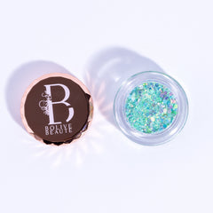 Close-up of mint green glitter eyeshadow in Mojito shade with sparkling shimmer particles in compact case