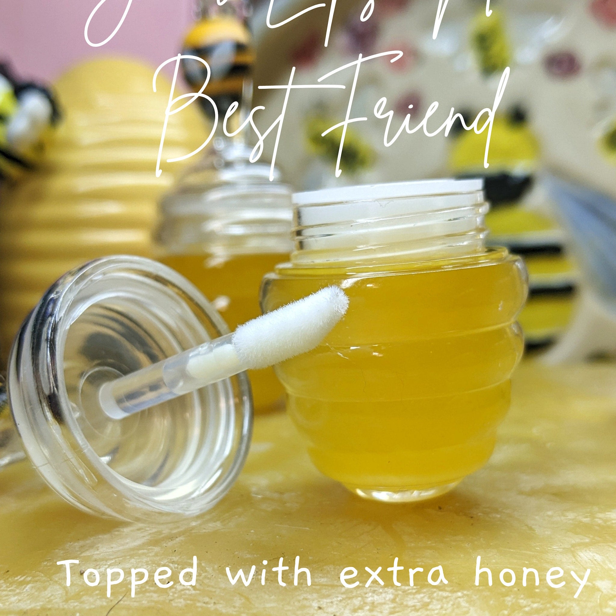 Lip gloss with yellow liquid, clear bottle, and white applicator, "Best Friend" text visible