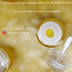 Lip gloss jar with yellow liquid, clear plastic, and white applicator, @boosbeesbeauty
