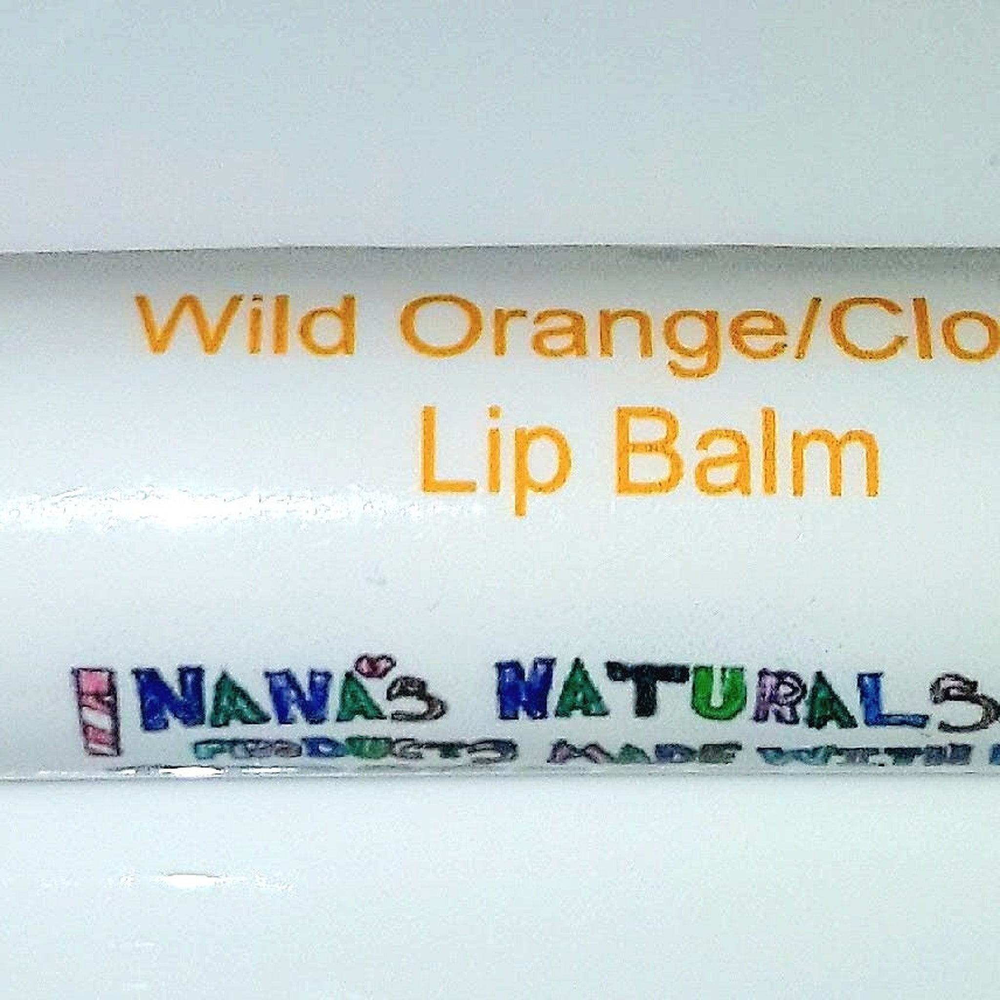 Lip balm with orange text and Nana's Naturals logo on white background