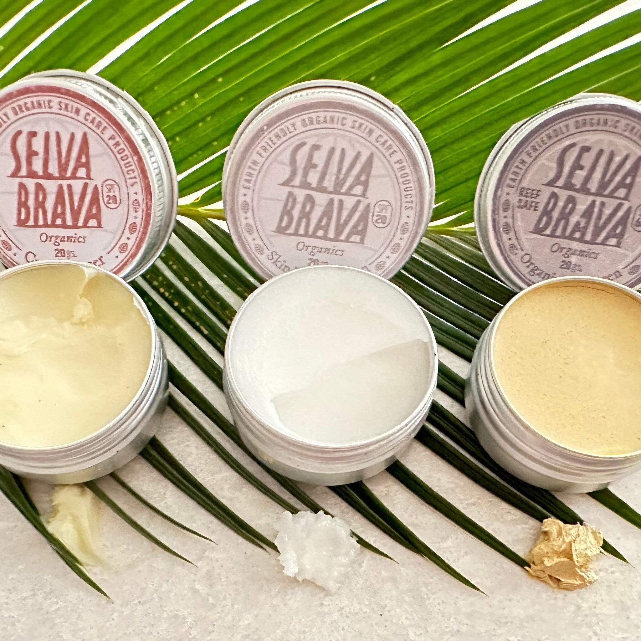Skin care products in silver tins with visible Selva Brava branding and cream textures