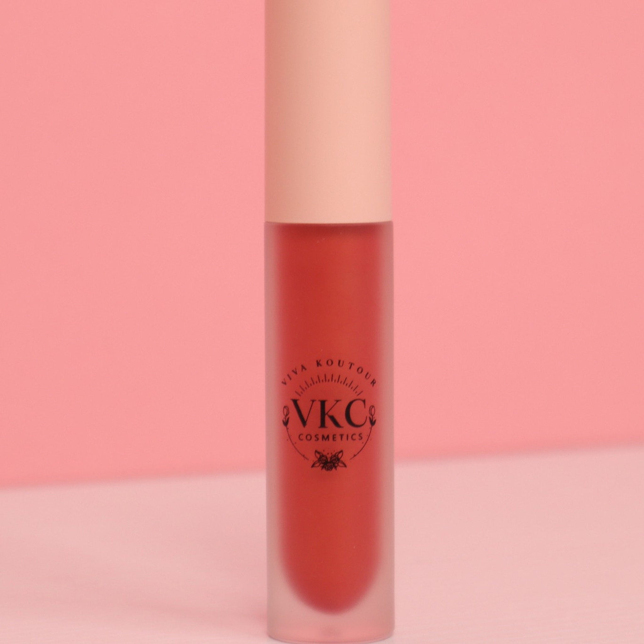 Lipstick tube, red liquid, frosted glass, pink cap, VCK Cosmetics logo visible