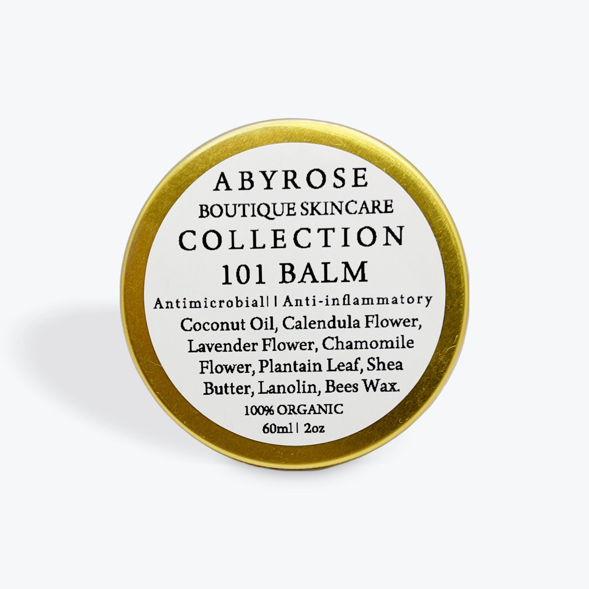 Balm tin with gold rim and white label, "Abyrose Collection" text visible