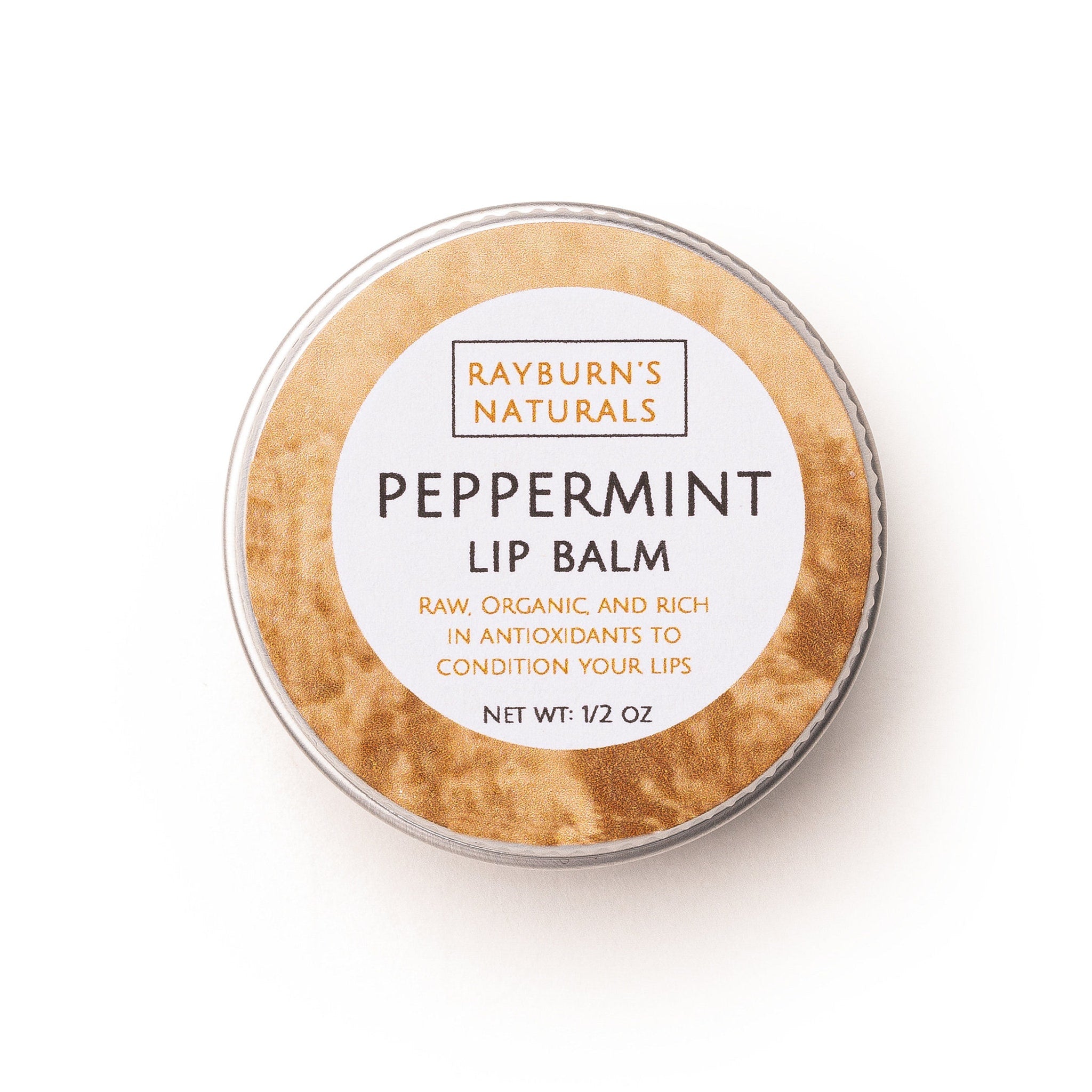 Lip balm tin with white label, brown texture, and Rayburn's Naturals text visible