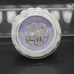 Eye shadow in aquamauve with gold lettering, in a clear plastic compact with white rim, Max Factor brand