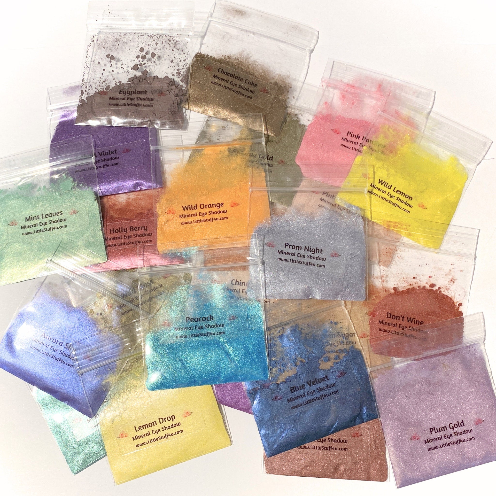 Mineral eyeshadow in various colors, packaged in clear plastic bags with printed labels from LittleStuff4u