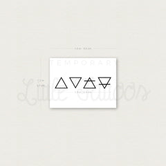 Temporary tattoo set with black geometric symbols on white backing, brand name visible