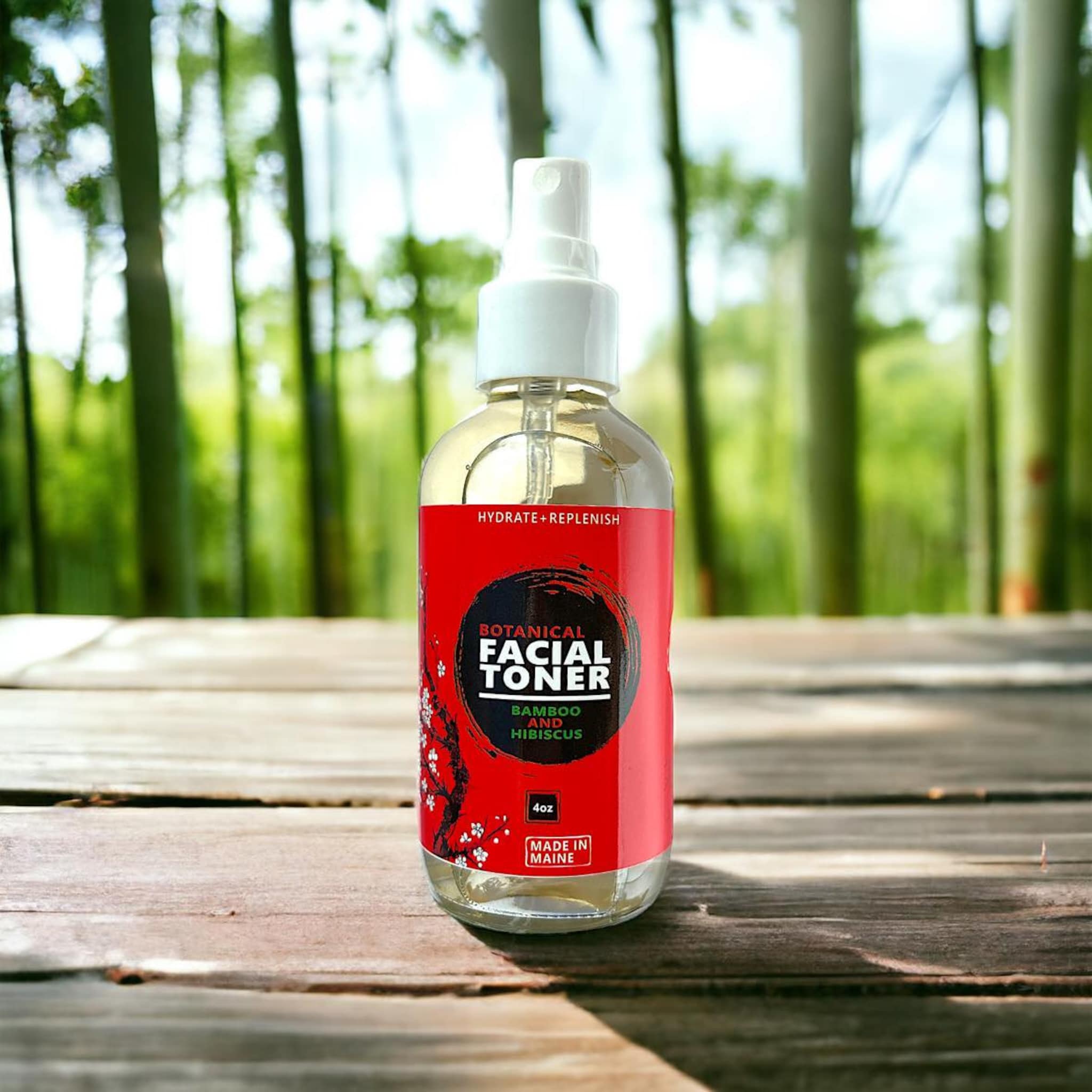 Facial toner bottle with red label, clear glass, white spray top, on wood surface