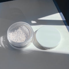 Powdered makeup in clear plastic jar with white lid, "GRACE" text visible