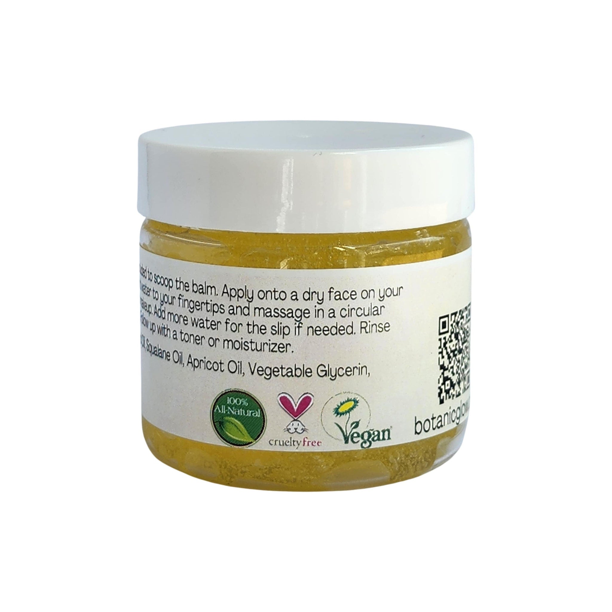 Balm jar with white lid, yellow contents, and white label with text and logos, for skincare use