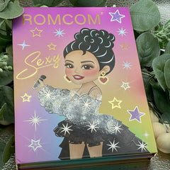 Eyeshadow palette book with gold lettering, illustration, and star accents, Selena brand