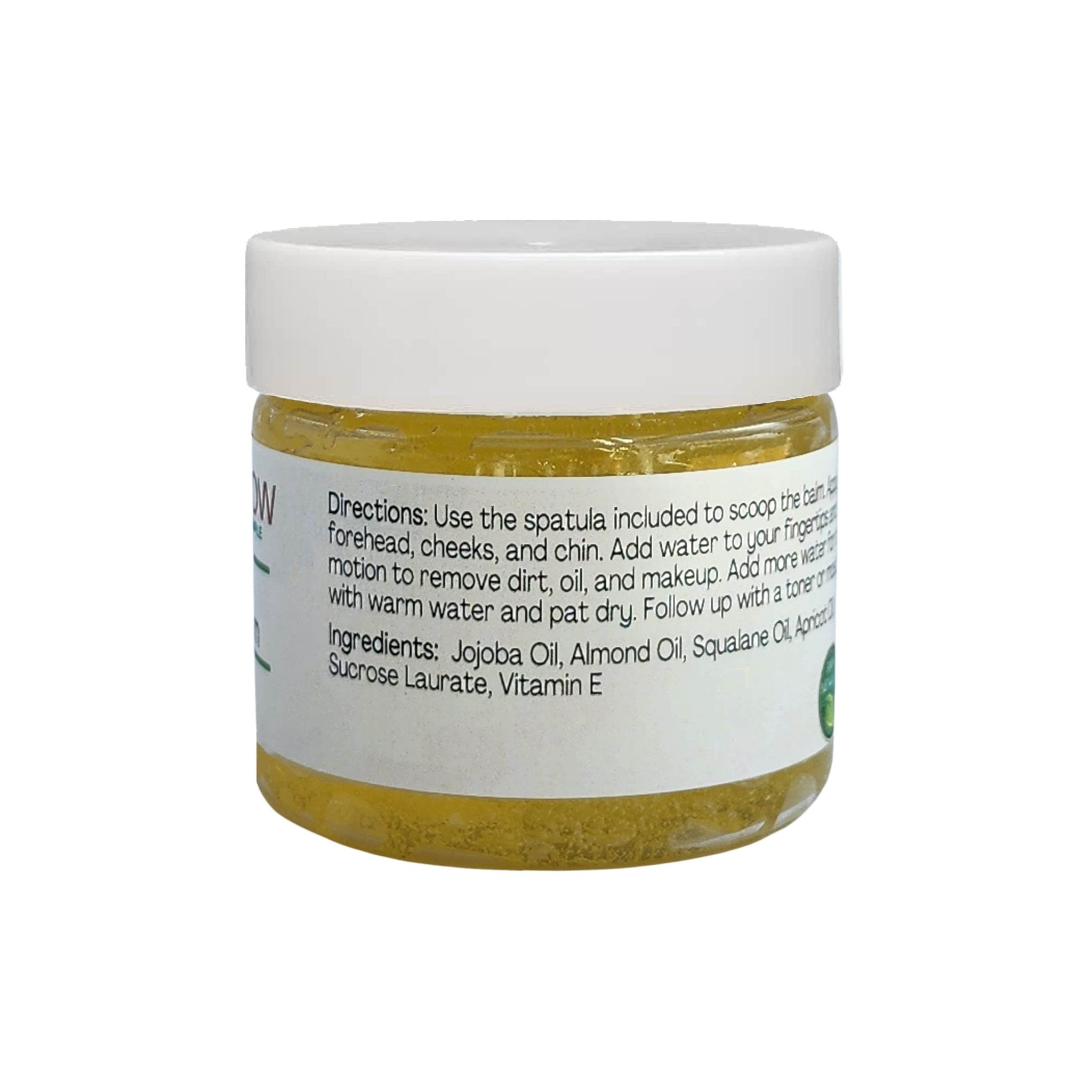 Facial balm jar with white lid, yellow contents, and product label visible