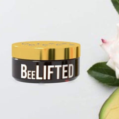 Cream jar with black and gold lid, white "BeeLIFTED" text, and floral background.