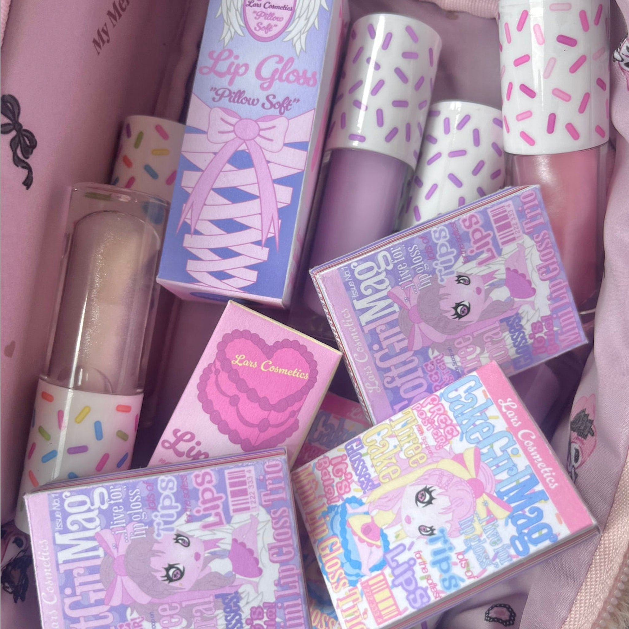 Lip gloss products in pink, purple, and white with sprinkle pattern, Lars Cosmetics packaging visible