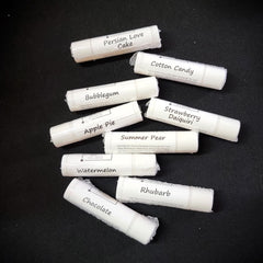 Lip balm tubes with white labels, KraftyChickStudios branding, and flavor names visible