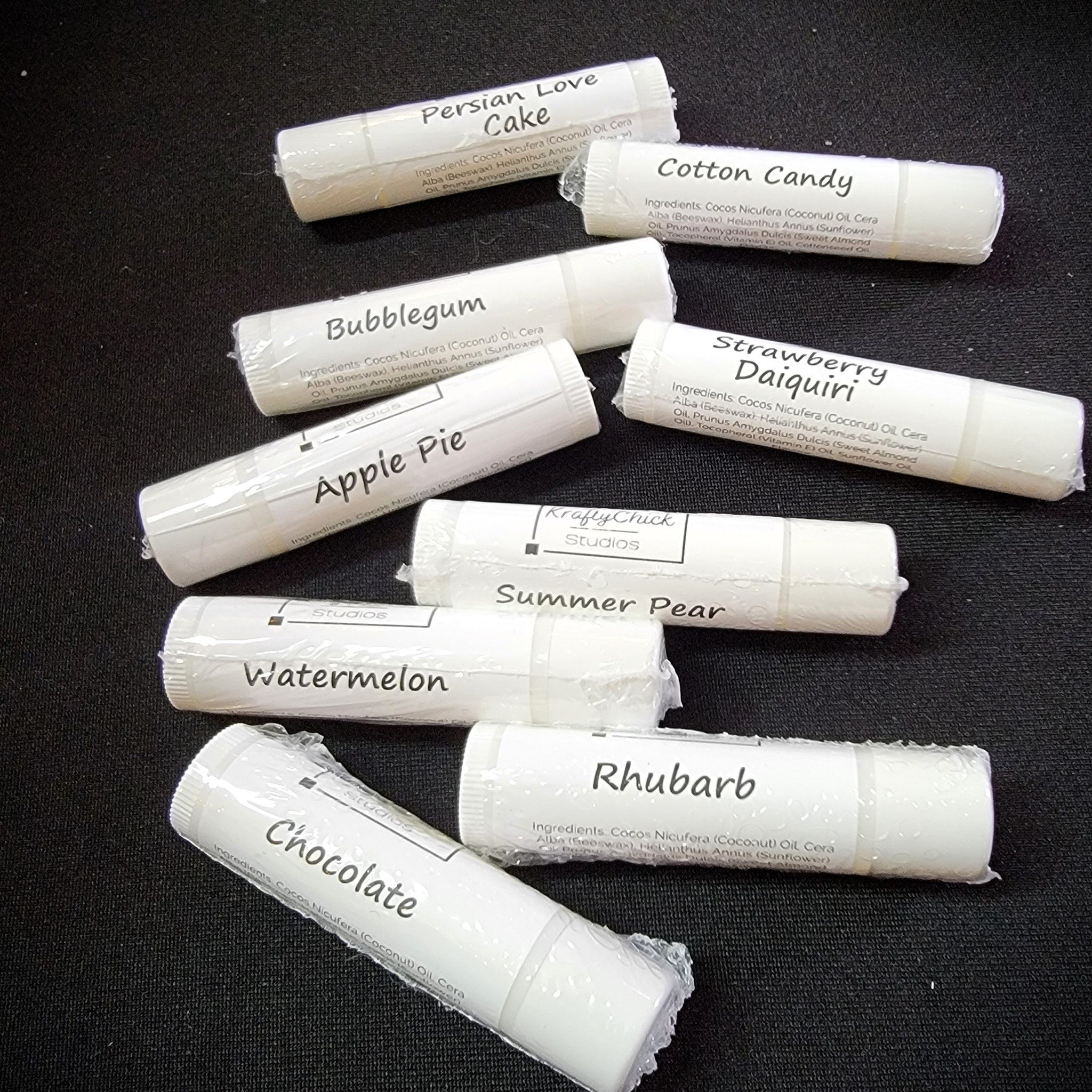 Lip balm tubes, white with flavor labels, wrapped in clear plastic, KraftyChickStudios brand