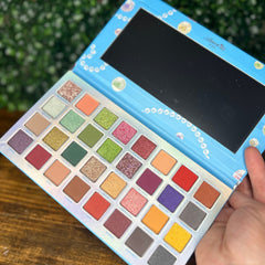 Pearl Paradise Eyeshadow Palette featuring six shimmering pastel shades in a sleek white compact with gold trim