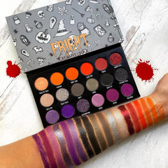 Close-up of Halloween Fright Eyeshadow Palette showing matte black, shimmer purple, and metallic orange shades in rectangular pans