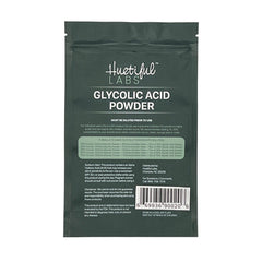Glycolic acid powder in dark green pouch, with "Huetiful Labs" text and product information printed on front.