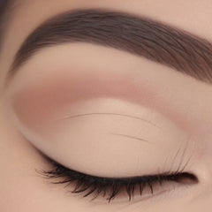 Single matte beige eyeshadow pan with smooth powder texture in minimalist white compact